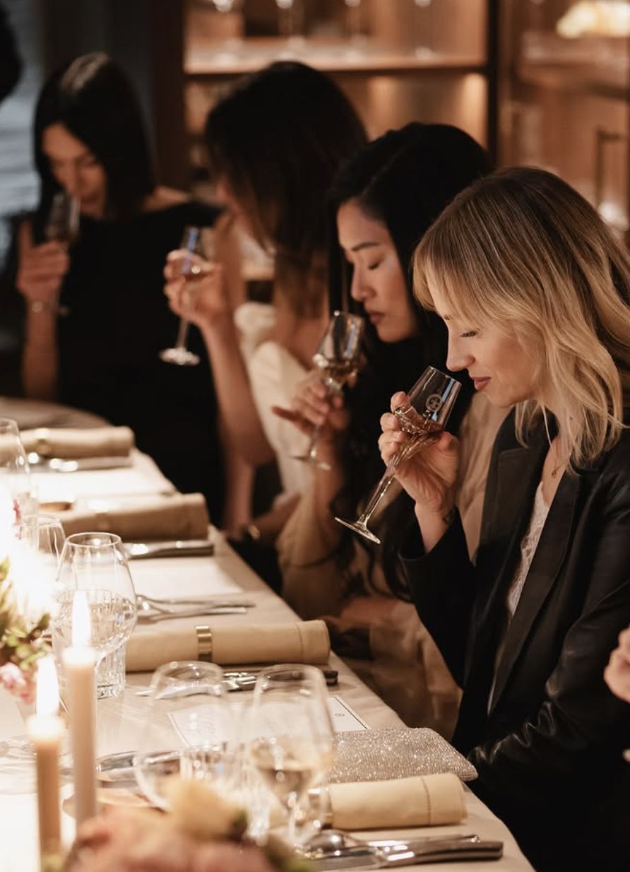 Guests tasting Louis XIII at a candlelit table