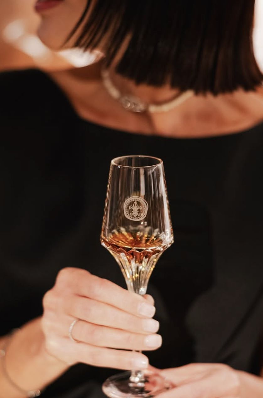 A guest holding a Louis XIII crystal glass