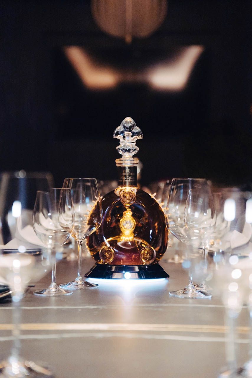 Louis XIII decanter surrounded by glassware